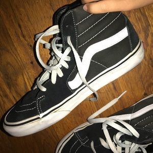 Black and white hightop Vans